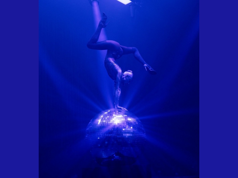 Calzedonia, Talents Productions, Villa Eugenie, mode sur mesure, performance acrobatique, artiste en équilibre, spectacle disco, extravagance de la mode à Milan, événement de la marque Calzedonia, divertissement de mode innovant, artiste disco, événement à Milan, artiste milanais.